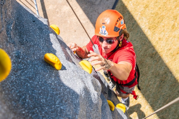 a boy wearing a helmet holding a baseball bat